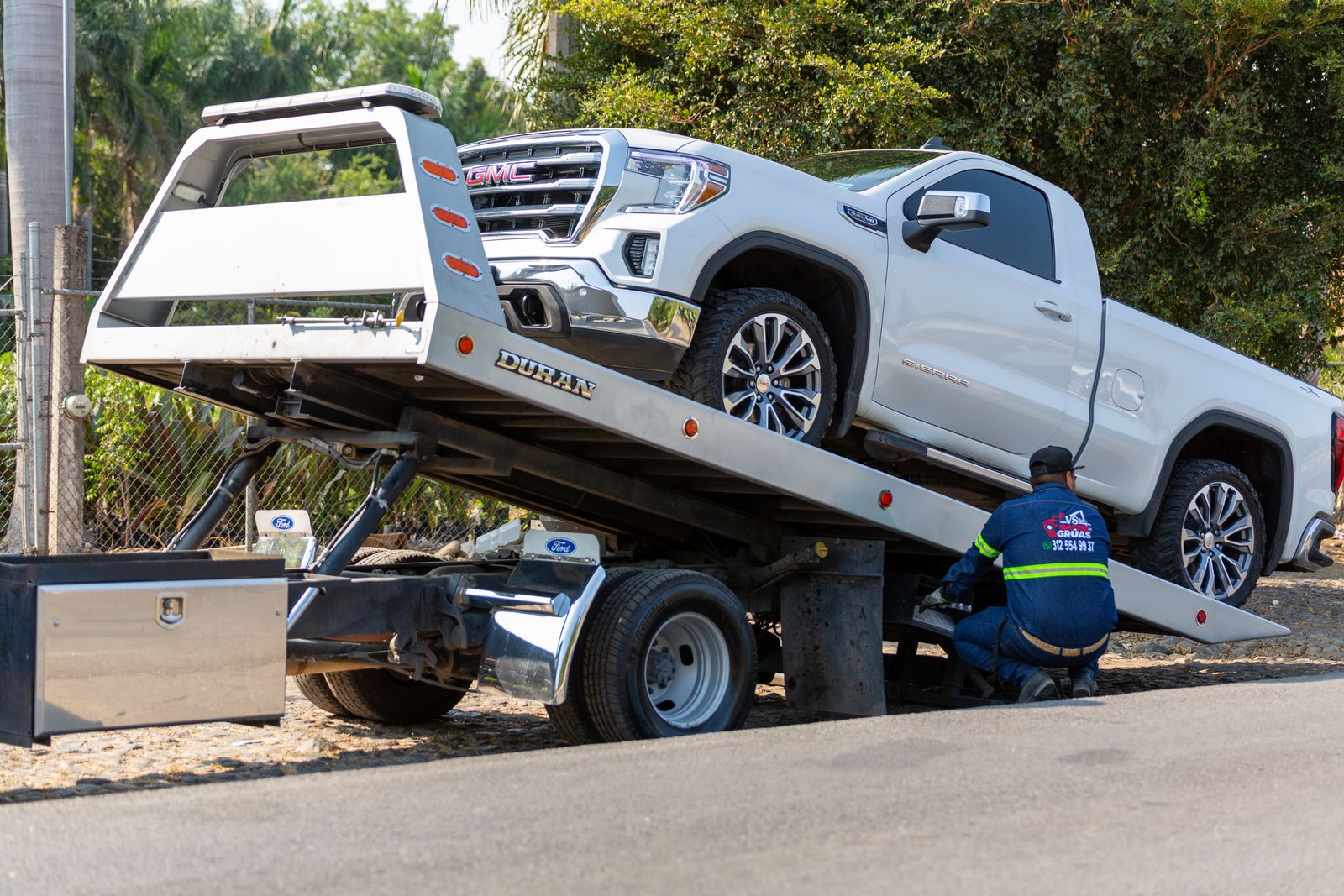 Roadside recovery operator loading a vehicle onto a tow truck